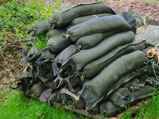 Stacked sacks sandbag filled with sand as flood protection.