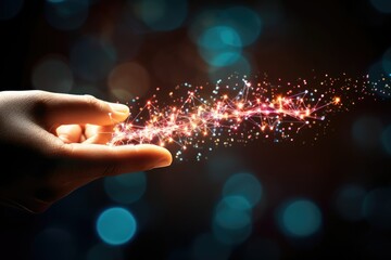 Hand with sparkling light trails on dark background