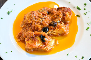 Pollo in potacchio is a regional recipe from Marche region in Italy cooked with tomato sauce, garlic, white wine olives