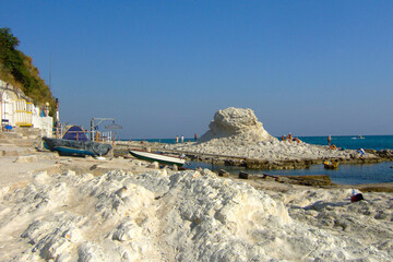 the rock called Sedia del Papa in front of the caves on the city beach and city cost of Ancona near...