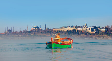 Fisherman with fishing boat in a calm sea - Famous historical peninsula of Istanbul - Hagia sophia, Sultanahmet Mosque, Topkapi palace -  istanbul, Turkey