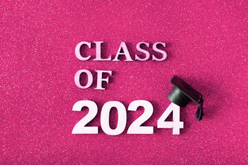Class of 2024 text with graduated cap. Graduation holiday concept.