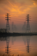 High voltage transmission tower and sunrise
