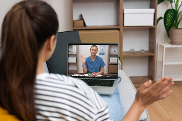 Smiling doctor greeting patient via video call, representing convenient and friendly telehealth services.