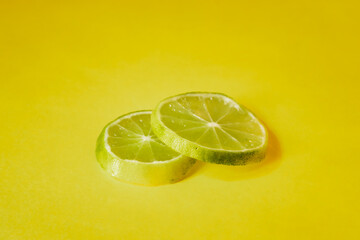 lemon slices against yellow background.