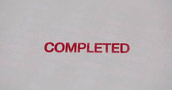 Hands on the document put a stamp completed, close-up. Element of business strategy, achievement