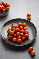 closeup cherry tomatoes on grey plate - 778952291