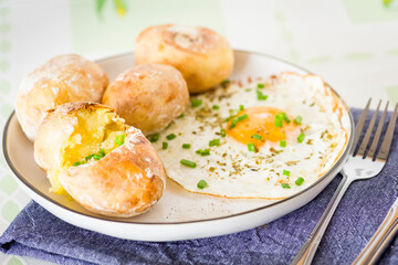 baked potatoes with fried eggs - 778953681