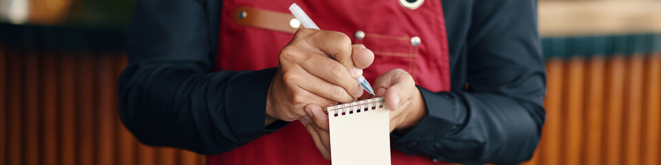 Web banner with waiter writing down order of customer