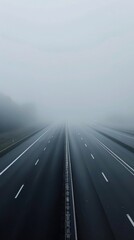 Fototapeta premium Empty highway stretching into a foggy horizon, with no cars in sight