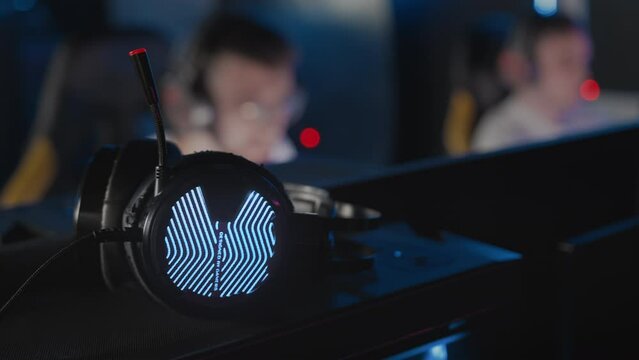 Close up professional headset RGB light Computer club competition. E-sport tournament championship with modern equipment. Team play video game. Tactics skill. Multiplayer shooter real-time strategy