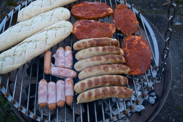 grilled sausages, meat and bread on the barbecue. Barbecue in the garden view from above