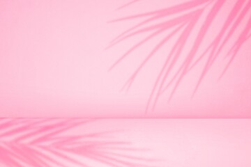 empty pastel pink studio room with palm shadow for products presentation. background of wall and...