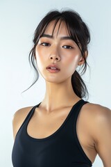 Full face no crop of a Pretty Young Korean Super Model in Sporty Yoga Leggings and Tank Top, emanating active energy with a focused gaze. photo on white isolated background