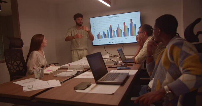 Architects huddle in the boardroom, dissecting construction blueprints and brainstorming innovative designs for an international startup.