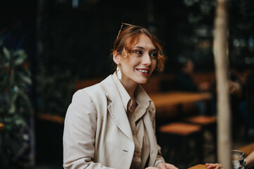 Portrait of a smiling businesswoman at an informal business gathering, discussing work with a...