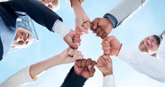 Teamwork, sky or business people with hands or fist for mission goals, collaboration or community. Team building, low angle or happy employees in meeting with support, solidarity or group motivation