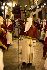 Hooded penitents during the famous Good Friday procession in Chieti (Italy) - 778979627