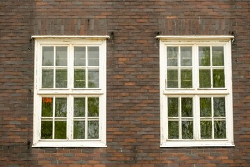 Fototapeta na wymiar old brick building with old double windows
