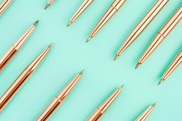 Set of colorful pens lined up on turquoise background with word pencil written on them