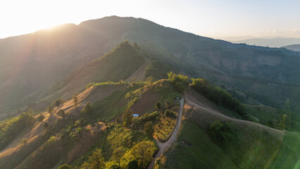 Aerial view of mountain and roadway, Beautiful landscape sunset with .golden sunlight.