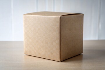 Brown cardboard box on a wooden table in front of a white wall