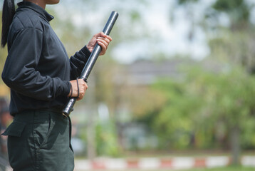 Female riot police practice using batons to control crowds.
