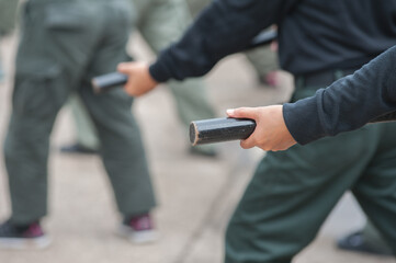 Obraz na płótnie Canvas Female riot police practice using batons to control crowds. 