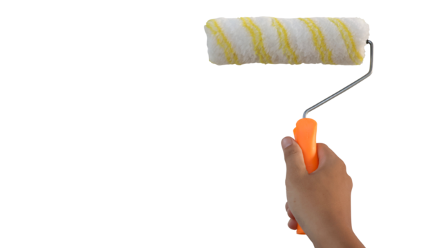 Hand holding fluffy paint roll for application of paint on the wall