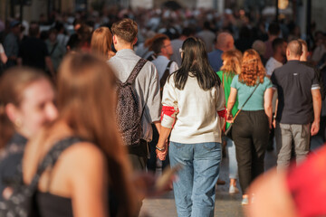 The sun-drenched people in the crowd capture the essence of modern European city life...