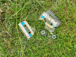 broken tape cassette in the grass flat view