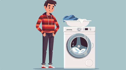 Unhappy young man standing next to washing machine