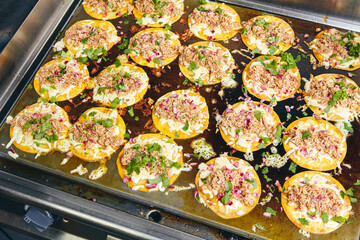 Frying tacos tortillas with cheese, onion, herbs and meat on griddle in professional kitchen in restaurant. Mexican cuisine, Latin American fast food