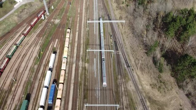 Pursuing a passenger train from above while passing a railway station