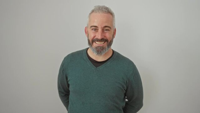 Cheeky, winking young man flashing a joyful smile in a cozy sweater. this cheery guy's got fun, natural charm! isolated on a crisp white background, he's an embodiment of positivity!