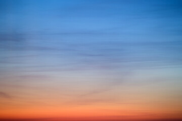 An abstract background of red-blue clouds in the dark evening sky - obrazy, fototapety, plakaty