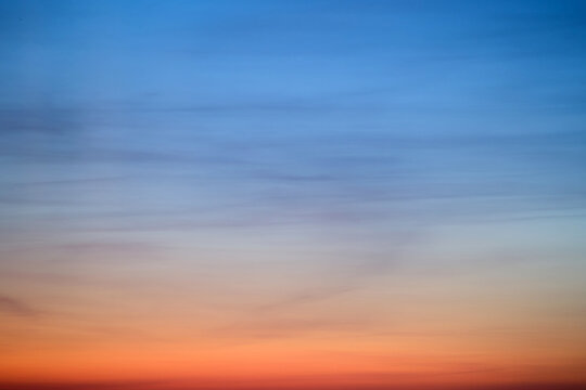 An abstract background of red-blue clouds in the dark evening sky