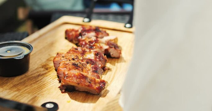 Spring barbecue. Grilled ribs on a wooden desk. Barbecue in nature