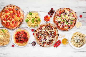 Delicious Italian food table scene. Selection of pizzas and pastas. Top down view on a white wood background. - 779043804