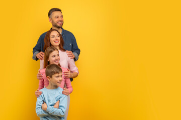 Family together with a cheerful expression on yellow background