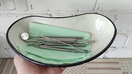 Dentist shows dental instruments in the tray