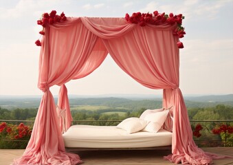 Pink draped four-poster bed with white pillows and red roses on a terrace with a view of the mountains