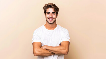 Fototapeta premium Caucasian handsome man isolated on beige background keeping the arms crossed