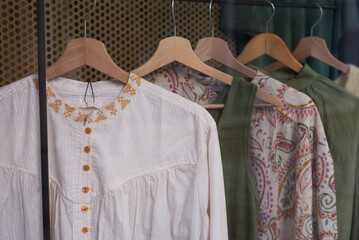 closeup of boho style clothes on hanger in a fashion store showroom