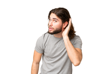 Young handsome man over isolated chroma key background listening to something by putting hand on the ear