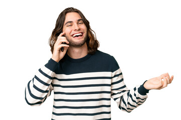 Young handsome man over isolated background keeping a conversation with the mobile phone with someone