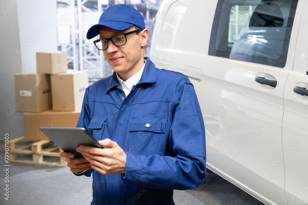 Poster manager with a digital tablet on the background of van. fleet and warehouse management..