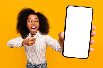 Excited woman showing a blank smartphone screen
