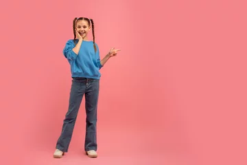 Gordijnen Girl posing with peace sign on pink background © Prostock-studio