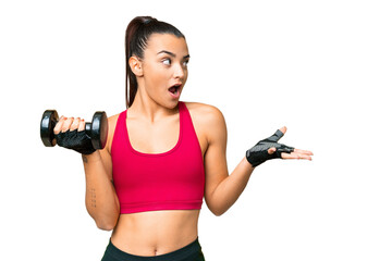 Young sport woman making weightlifting with surprise facial expression